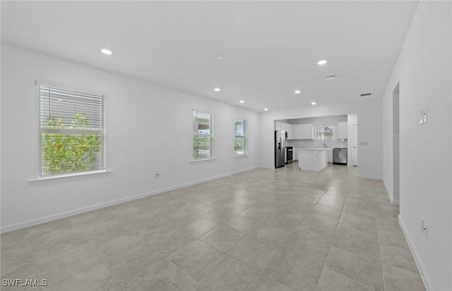 44225 Kelly Dr, Punta Gorda, FL 33982 - unfurnished living room featuring recessed lighting and baseboards