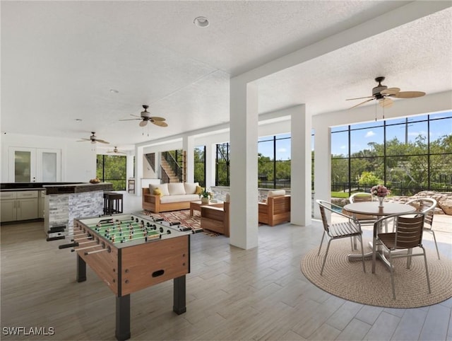 18251 Parkridge Ct, Fort Myers, FL 33908 - rec room with ceiling fan, a textured ceiling, and light wood-style flooring