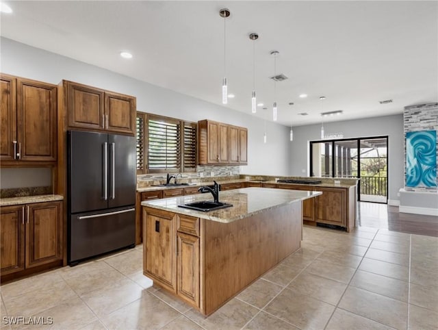 18251 Parkridge Ct, Fort Myers, FL 33908 - kitchen with high end fridge, a sink, a peninsula, recessed lighting, and a kitchen island with sink