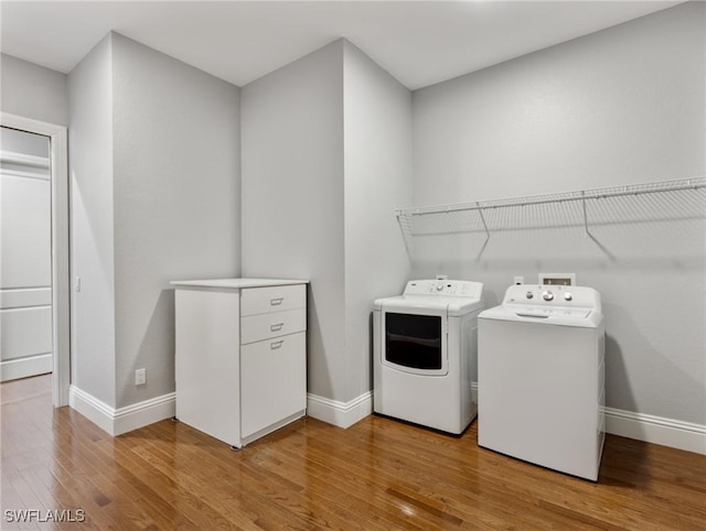 18251 Parkridge Ct, Fort Myers, FL 33908 - laundry area featuring washer and clothes dryer, baseboards, and light wood-style flooring