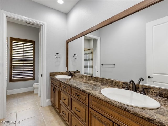 18251 Parkridge Ct, Fort Myers, FL 33908 - full bathroom featuring toilet, double vanity, tile patterned flooring, baseboards, and curtained shower