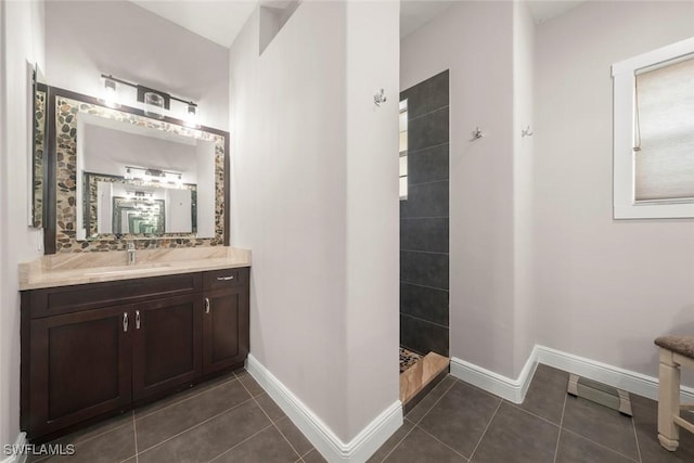 646 Vintage Reserve Cir Unit 4D, Naples, FL 34119 - bathroom featuring vanity, a walk in shower, tile patterned flooring, and baseboards