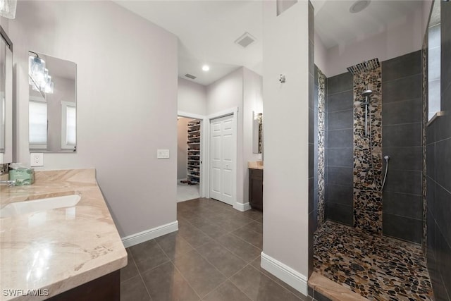 646 Vintage Reserve Cir Unit 4D, Naples, FL 34119 - bathroom featuring double vanity, walk in shower, baseboards, and recessed lighting