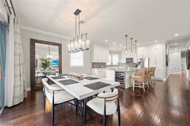 646 Vintage Reserve Cir Unit 4D, Naples, FL 34119 - dining area with beverage cooler, dark wood-type flooring, crown molding, a chandelier, and baseboards