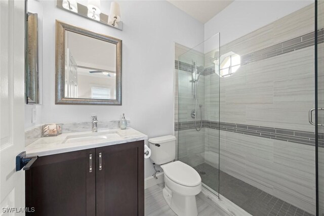 646 Vintage Reserve Cir Unit 4D, Naples, FL 34119 - bathroom with toilet, vanity, a shower stall, and tile patterned floors