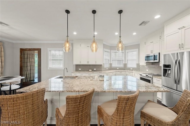 646 Vintage Reserve Cir Unit 4D, Naples, FL 34119 - kitchen with stainless steel appliances, a sink, decorative backsplash, plenty of natural light, and crown molding