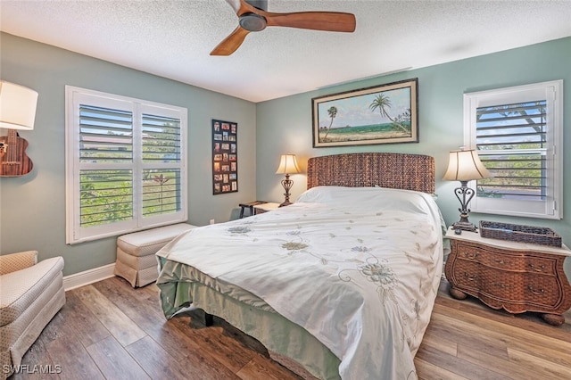 5741 Whitaker Rd Unit D103, Naples, FL 34112 - bedroom with wood finished floors, a textured ceiling, baseboards, and ceiling fan