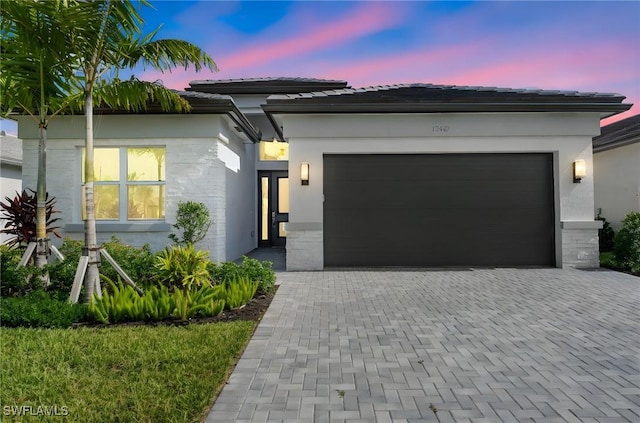12467 Purple Ficus Way, Naples, FL 34120 - view of front of house featuring an attached garage, decorative driveway, and stucco siding