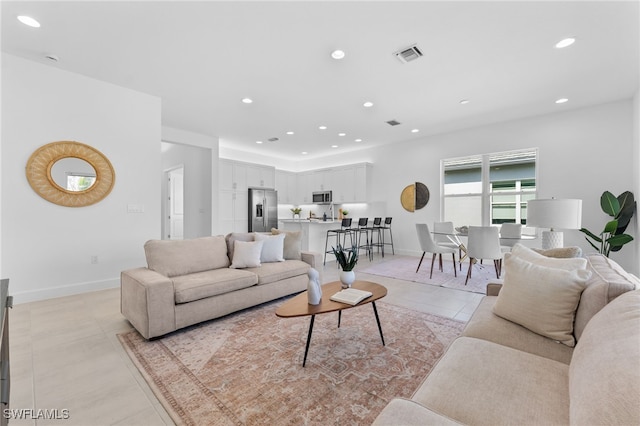 12467 Purple Ficus Way, Naples, FL 34120 - living area with light tile patterned floors, recessed lighting, and baseboards