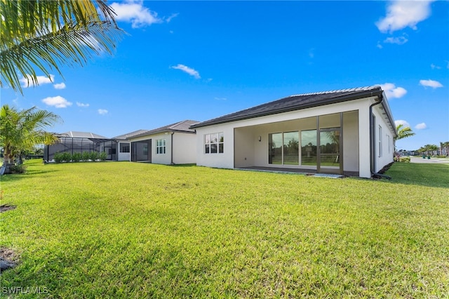 12467 Purple Ficus Way, Naples, FL 34120 - back of house with stucco siding and a lawn