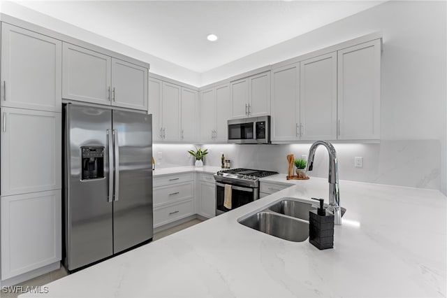 12467 Purple Ficus Way, Naples, FL 34120 - kitchen featuring appliances with stainless steel finishes, a sink, light stone counters, and recessed lighting