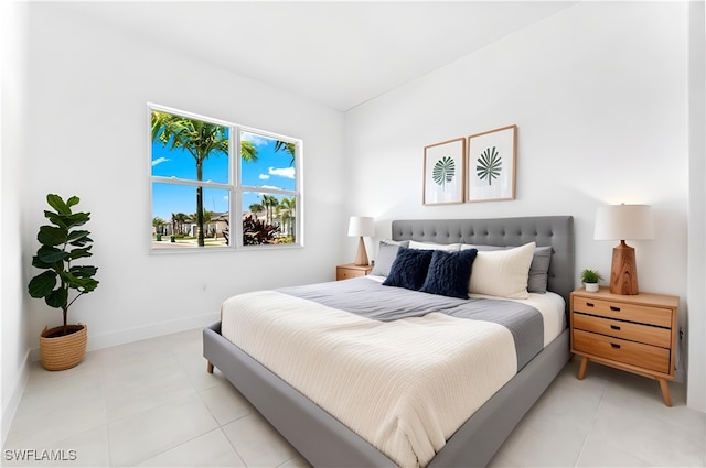 12467 Purple Ficus Way, Naples, FL 34120 - bedroom with light tile patterned floors and baseboards