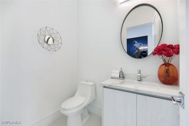 1167 22nd Ave N, Naples, FL 34103 - bathroom featuring vanity, toilet, tile patterned flooring, and baseboards