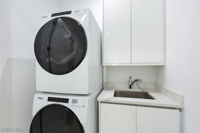 1167 22nd Ave N, Naples, FL 34103 - laundry room featuring estacked washer and dryer and cabinet space