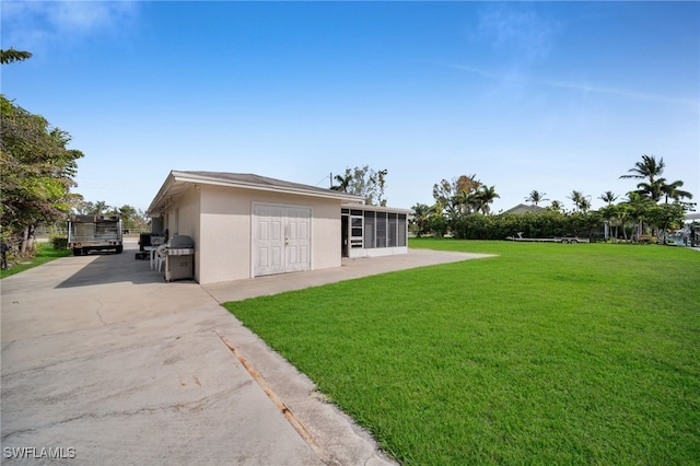 14260 Mcgregor Blvd, Fort Myers, FL 33919 - view of grassy yard with a sunroom and driveway