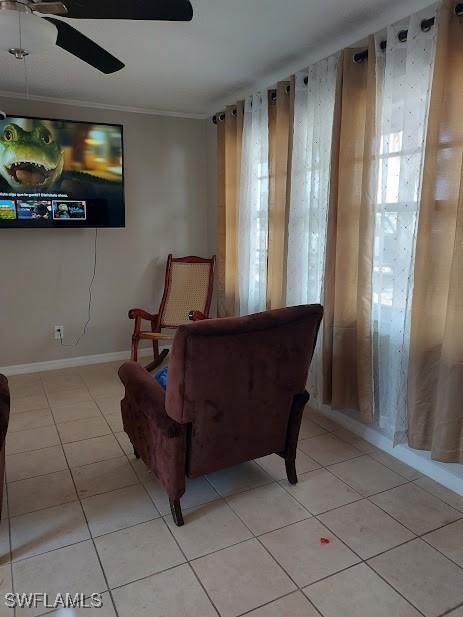 11421 Kimble Dr Unit 423, Fort Myers, FL 33908 - living area featuring light tile patterned floors, a ceiling fan, and ornamental molding