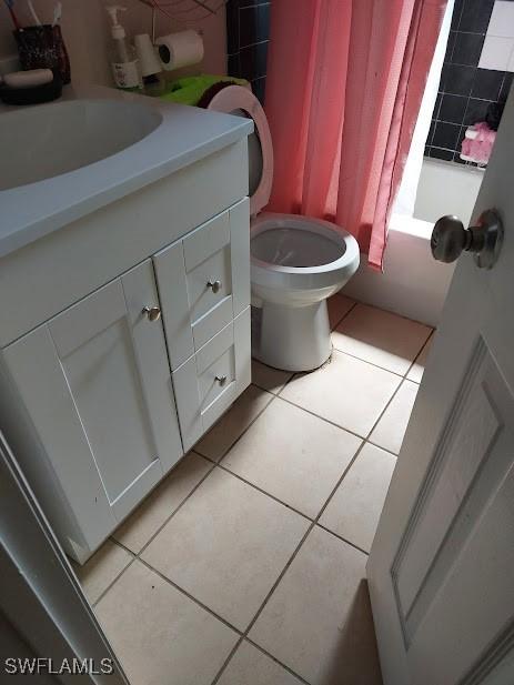 11421 Kimble Dr Unit 423, Fort Myers, FL 33908 - full bathroom with tile patterned flooring, vanity, toilet, and shower / bathtub combination with curtain