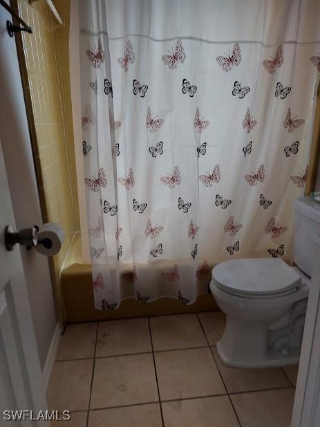 11421 Kimble Dr Unit 423, Fort Myers, FL 33908 - full bathroom featuring toilet, shower / bath combo with shower curtain, and tile patterned flooring