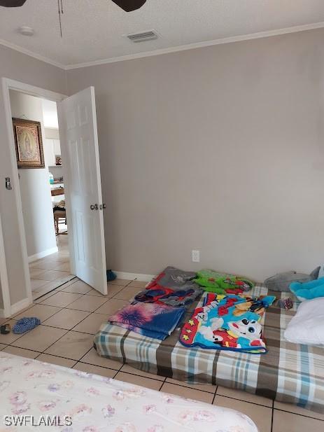 11421 Kimble Dr Unit 423, Fort Myers, FL 33908 - bedroom with ornamental molding, light tile patterned floors, and baseboards