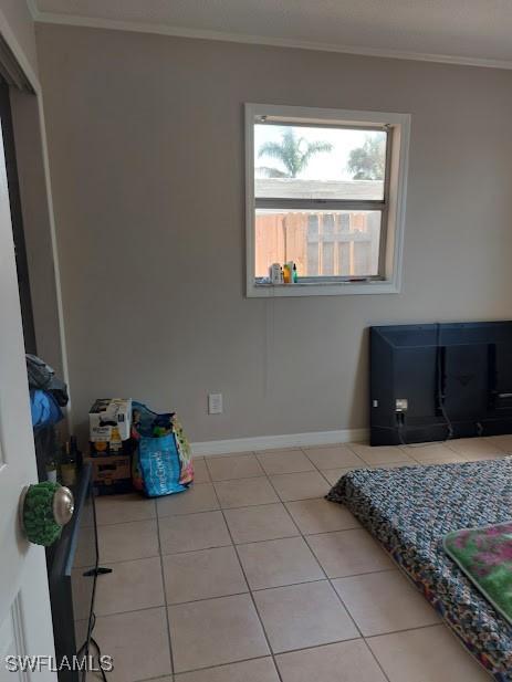 11421 Kimble Dr Unit 423, Fort Myers, FL 33908 - tiled bedroom featuring ornamental molding and baseboards