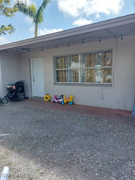 11421 Kimble Dr Unit 423, Fort Myers, FL 33908 - view of exterior entry featuring stucco siding