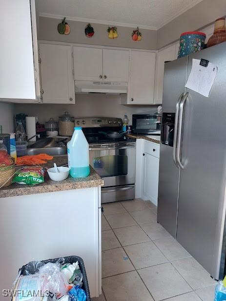 11421 Kimble Dr Unit 423, Fort Myers, FL 33908 - kitchen with appliances with stainless steel finishes, under cabinet range hood, and white cabinetry