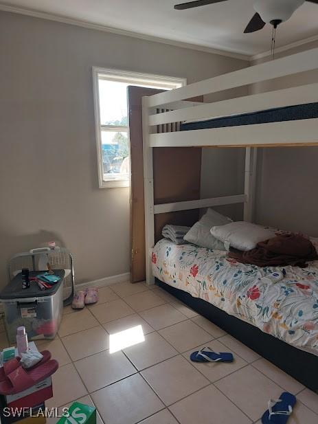 11421 Kimble Dr Unit 423, Fort Myers, FL 33908 - bedroom with ornamental molding, light tile patterned floors, baseboards, and a ceiling fan