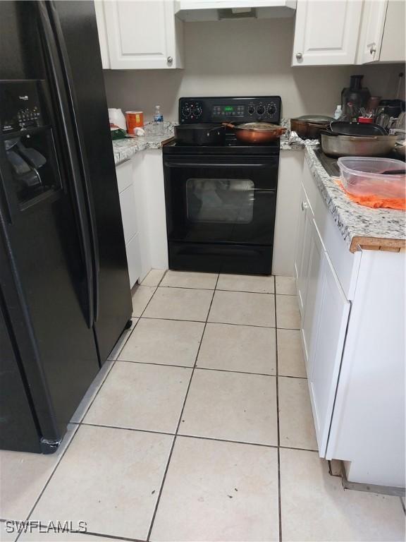 11421 Kimble Dr Unit 423, Fort Myers, FL 33908 - kitchen featuring black appliances, white cabinets, light countertops, and exhaust hood