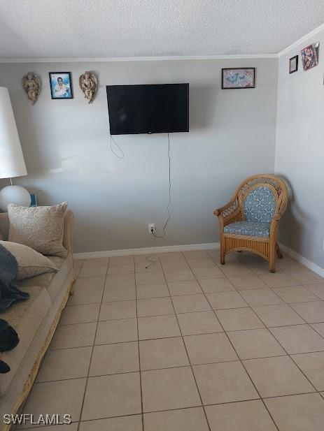 11421 Kimble Dr Unit 423, Fort Myers, FL 33908 - living room featuring crown molding, a textured ceiling, baseboards, and light tile patterned floors