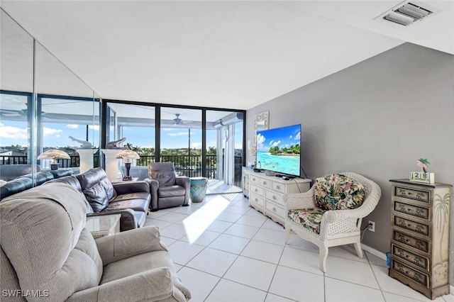 10562 Gulf Shore Dr Unit 402, Naples, FL 34108 - living room with expansive windows, light tile patterned floors, a sunroom, and baseboards