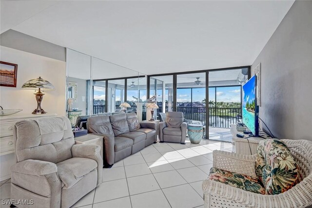10562 Gulf Shore Dr Unit 402, Naples, FL 34108 - living room featuring a wall of windows, light tile patterned flooring, and healthy amount of natural light