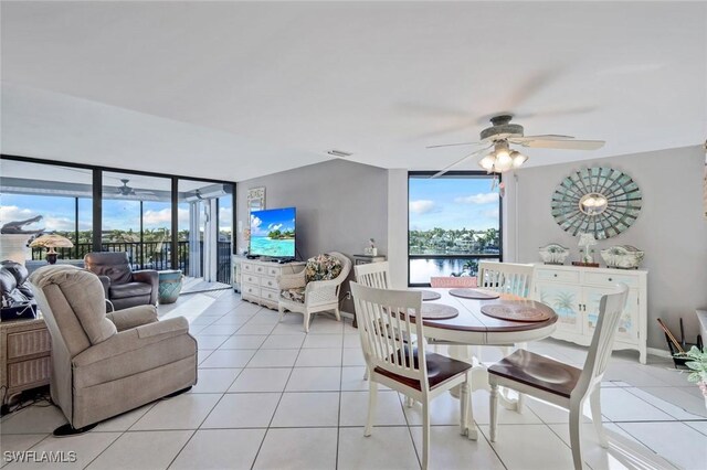 10562 Gulf Shore Dr Unit 402, Naples, FL 34108 - dining room featuring ceiling fan, light tile patterned floors, plenty of natural light, and expansive windows