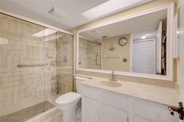 10562 Gulf Shore Dr Unit 402, Naples, FL 34108 - bathroom featuring toilet, vanity, a stall shower, and tile patterned floors