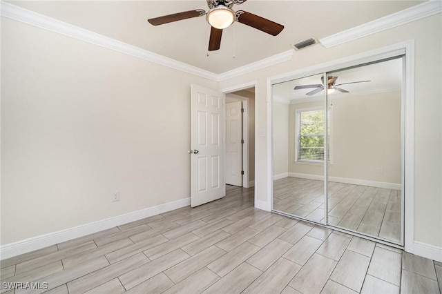 1400 Billie St, Fort Myers, FL 33916 - unfurnished bedroom with crown molding, wood tiled floors, a ceiling fan, baseboards, and a closet