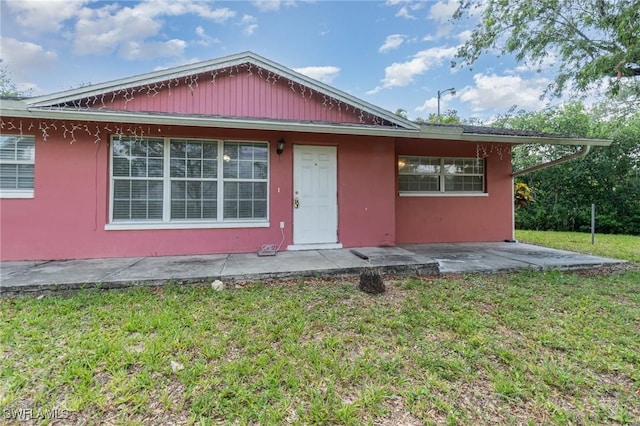 1400 Billie St, Fort Myers, FL 33916 - bungalow featuring a front yard, a patio, and stucco siding