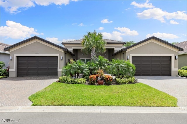 28648 Lobos Cir, Bonita Springs, FL 34135 - ranch-style house with stucco siding, a garage, driveway, and a front yard