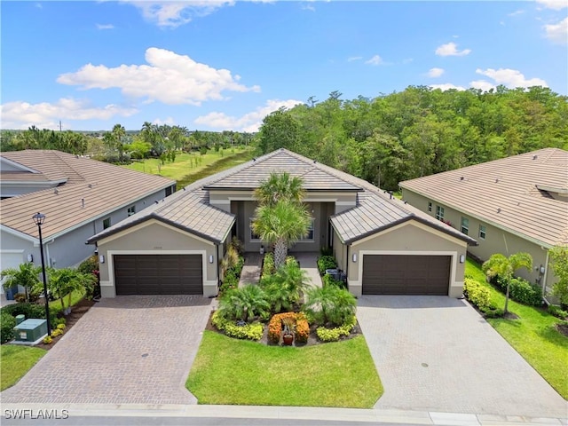 28648 Lobos Cir, Bonita Springs, FL 34135 - ranch-style house featuring stucco siding, decorative driveway, and a front lawn
