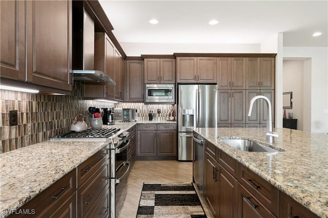 28648 Lobos Cir, Bonita Springs, FL 34135 - kitchen featuring stainless steel appliances, a sink, wall chimney range hood, tasteful backsplash, and recessed lighting