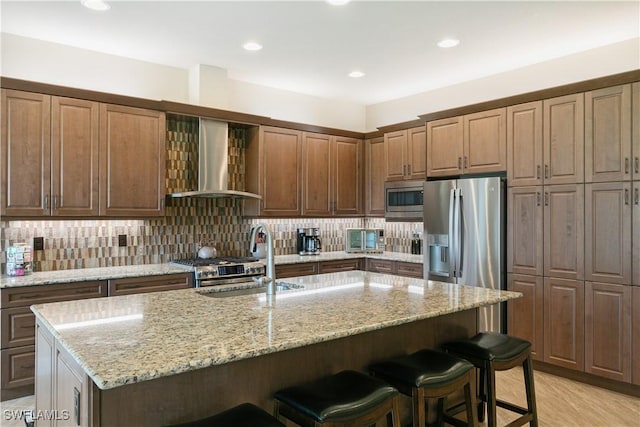 28648 Lobos Cir, Bonita Springs, FL 34135 - kitchen with wall chimney exhaust hood, a sink, appliances with stainless steel finishes, a kitchen breakfast bar, and recessed lighting