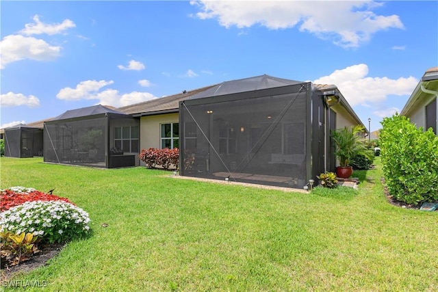 28648 Lobos Cir, Bonita Springs, FL 34135 - rear view of property with a yard, a lanai, and stucco siding