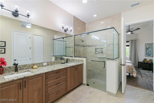 28648 Lobos Cir, Bonita Springs, FL 34135 - bathroom with ensuite bath, a shower stall, double vanity, and a ceiling fan