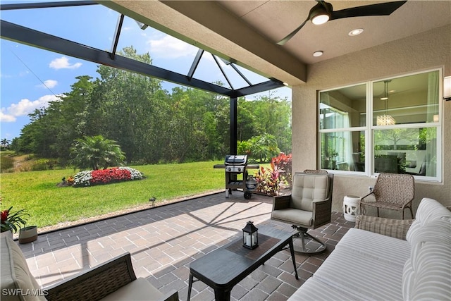 28648 Lobos Cir, Bonita Springs, FL 34135 - view of patio with ceiling fan, area for grilling, and glass enclosure