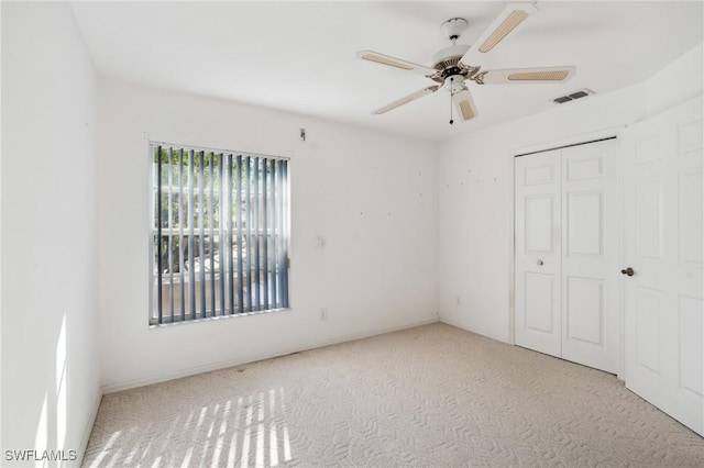24797 Lakemont Cove Ln Unit 202, Bonita Springs, FL 34134 - unfurnished bedroom featuring carpet, a closet, and a ceiling fan