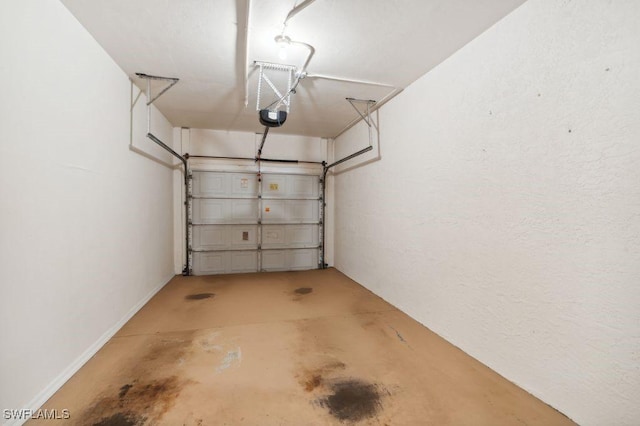 24797 Lakemont Cove Ln Unit 202, Bonita Springs, FL 34134 - garage with a garage door opener and baseboards
