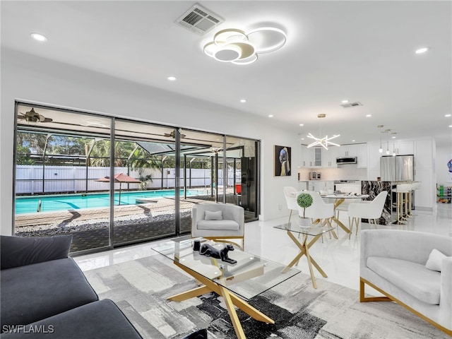 208 Erie Dr, Naples, FL 34110 - living room with recessed lighting and a chandelier