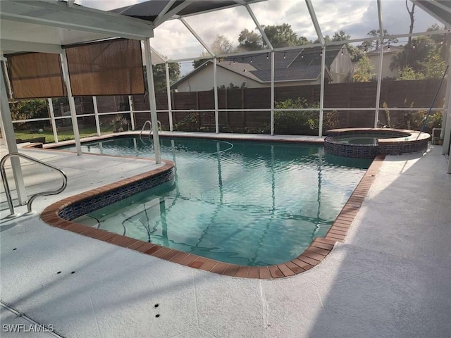 7821 Deni Dr, North Fort Myers, FL 33917 - view of pool featuring a fenced backyard, glass enclosure, and a pool with connected hot tub