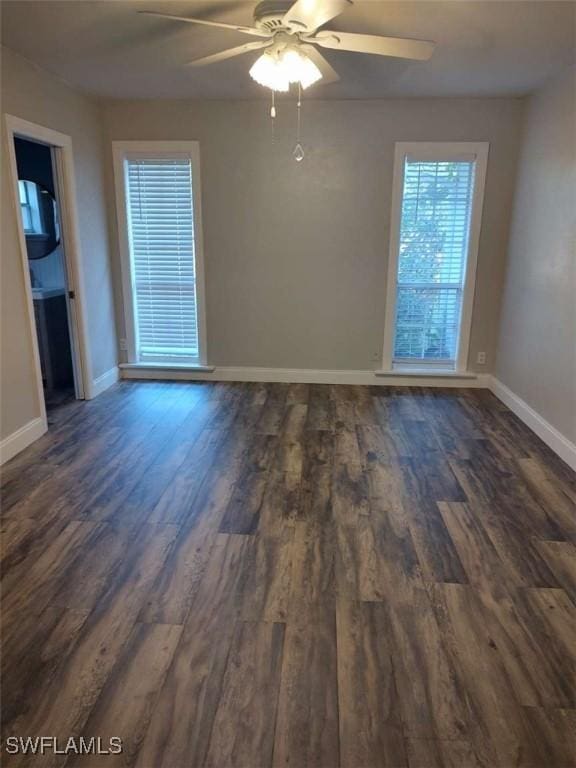 7821 Deni Dr, North Fort Myers, FL 33917 - spare room featuring dark wood-type flooring, ceiling fan, and baseboards