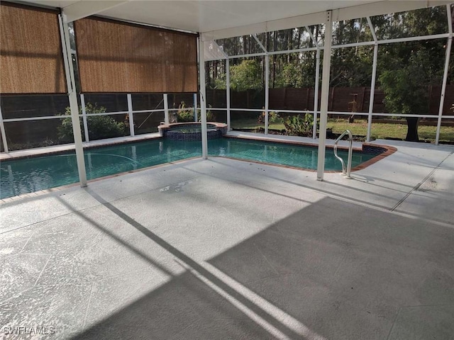 7821 Deni Dr, North Fort Myers, FL 33917 - view of pool featuring a patio area, a fenced backyard, a pool with connected hot tub, and a lanai