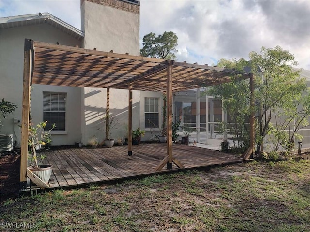 7821 Deni Dr, North Fort Myers, FL 33917 - back of property featuring a pergola, a wooden deck, and stucco siding