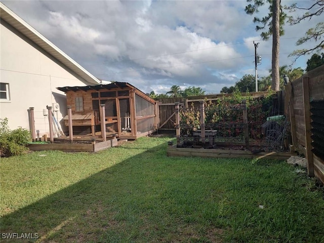 7821 Deni Dr, North Fort Myers, FL 33917 - view of yard featuring a garden and exterior structure